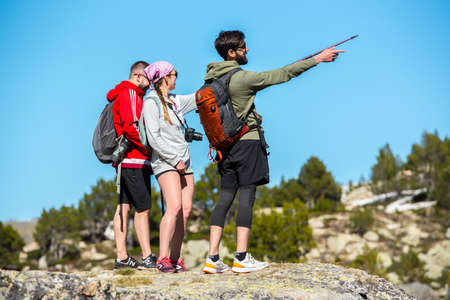 Grau Roig, Andorra : May 20 2020 : Three young hikers are Lake in the circuit of Lake Pessons Grau Roig, Andorra in spring.のeditorial素材