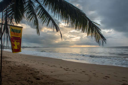 Tangalle, Sri Lanka : 2020 NOV 25 : Flag of  in the Sunset in the beach of Tangalle, Sri Lanka.のeditorial素材