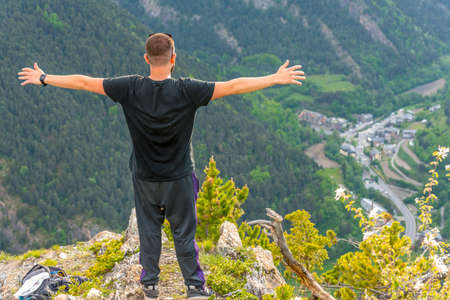 La Massana, Andorra: May 20, 2020: Man on a stone above the city of La Massana in the Principality of Andorra.のeditorial素材