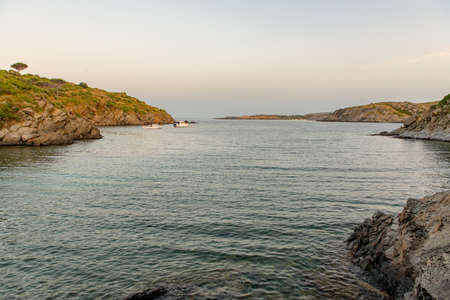 Spain Costa Brava peaceful pebble beach of the Mediterranean sea, Cala Guillola, Cadaques, Cap de...