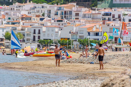Port de la Selva, Spain: 9 July 2020: People in the beach of Port de la Selva, one of the most touristic villages of Costa Brava, on August 9, 2013, in Port de la Selva, Catalonia, Spain.のeditorial素材