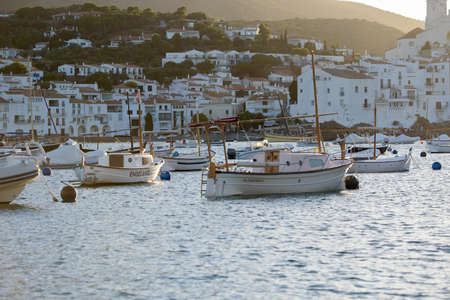 Cadaques, Spain: 07 JULY 2020: Boats in the beach and houses of the village of Cadaques, Spain in...