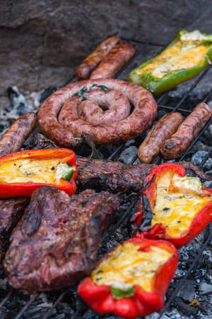 Closeup take of a traditional Argentinian and Uruguayan barbecue and peppers ehit eggs and cheese.の写真素材