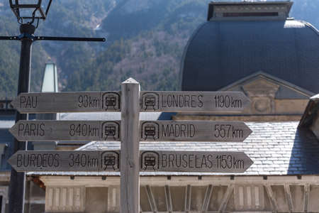 Canfranc, Spain - May 1, 2019: Sign giving direction to different cities in the Abandoned railway...