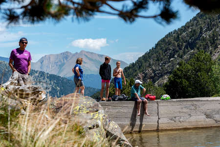 Coma Pedrosa, Andorra: 02 August 2020: Group of tourists resting at Lago de les Truites in Andorra Pyrenees in summer 2020.のeditorial素材