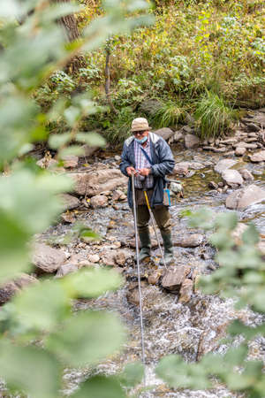 Ordino, Andorra: 26 August 2020: Fischerman enjoying the Valira del Orient river in Cami Ral in summer in Andorra.のeditorial素材