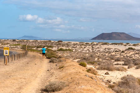 Corralejo, Fuerteventura, Spain: 2020 October 30: Young man running in the Dunas de Corralejo...