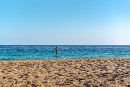 Morro Jable, Fuerteventura, Spain: 2020 October 08: Man paddle surfing from Morro Jable on Fuerteventura Island in Spain in the summer of 2020.のeditorial素材
