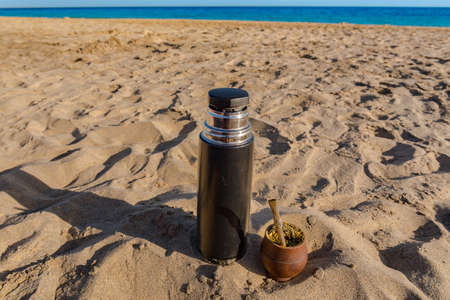 The Mate drink from Uruguay, Argentina, Paraguay and Brazil. Modern matte color brown in the beach.
