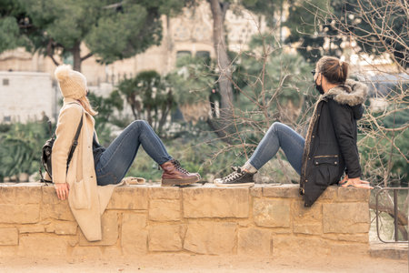 Barcelona, Spain: December 30 2020: Young womans in the Basicila and Expiatory Church of the Holy Family, known as Sagrada Familia at sunset in COVID Time.のeditorial素材