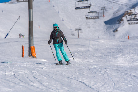 Pas de la Casa, Andorra: January 3, 2021: Young woman skiing in the Pyrenees at the Grandvalira ski resort in Andorra in Covid19 timeのeditorial素材