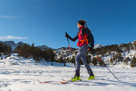 Woman in the mountains practicing mountain skiing in the Pyrenees of Andorra in 2021.