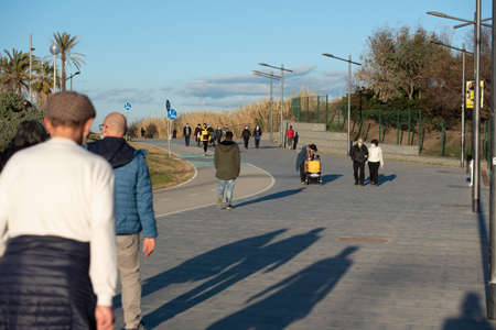 Barcelona, Spain: 2021 February 12: People walk along the Barcelona promenade in time of Covid 19 in winter 2021.のeditorial素材