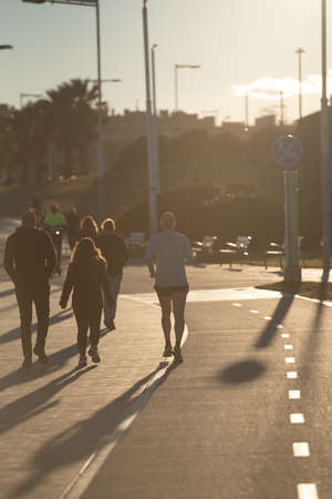 Barcelona, Spain: 2021 February 12: Man runs along the Barcelona promenade in time of Covid 19 in winter 2021.のeditorial素材