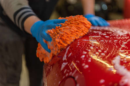 Andorra La Vella, Andorra: 2021 March 28: Team washing a Ferrarri 488 in an artisanal way in Andorra...