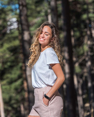 Pretty girl in the woods with hat in the woods in spring.