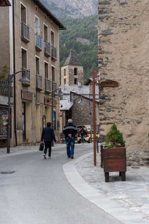 Ordino, Andorra: 2021 March 30: People walking down the street in spring in Ordino, Andorra in the Pyrenees in 2021.のeditorial素材