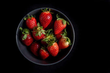 Strawberries in background black.の写真素材