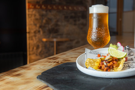 Arinsal, Andorra: 2021 April 29: Beer accompanied by a taco al Pastor. Typical Mexican foodのeditorial素材