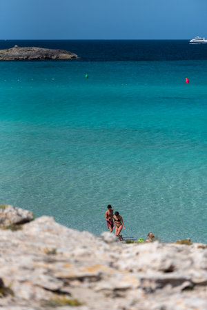 Formentera, Spain: 2021 My 26: People on the coast of Ses Illetes beach in Formentera, Balearic Islands in Spain.のeditorial素材