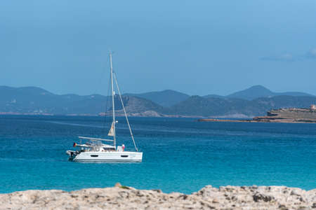 Formentera, Spain: 2021 My 26: Boats moored on the coast of Ses Illetes beach in Formentera,...