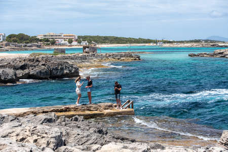 Formentera, Spain: 2021 May 29: Young people taking photos at Es Pujols beach in Formentera in the summer of 2021のeditorial素材