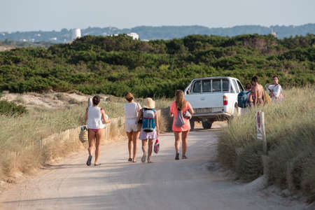 Formentera, Spain: 2021 June 13: Tourists cycling on the Illetes Beach in Formentera in Spain in times of Covid19のeditorial素材