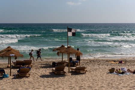 Formentera, Spain: 2021 June 21: People enjoying the sun at Es Arenals beach in Formentera, Spain in...