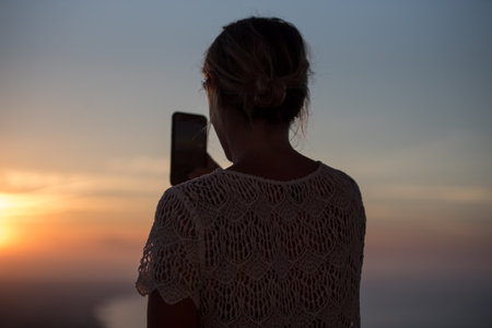 Woman take a picture in the island of Formentera in the Balearic Islands in Spain at Sunset