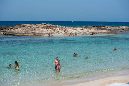 Formentera, Spain: July 11, 2021: People on the beach at Es Pujols beach in Formentera in summer 2021のeditorial素材