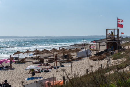 Formentera, Spain: 2021 June 21: People enjoying the sun at Es Arenals beach in Formentera, Spain in the summer of 2021.のeditorial素材