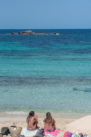 Formentera, Spain: July 11, 2021: People on the beach at Es Pujols beach in Formentera in summer 2021のeditorial素材