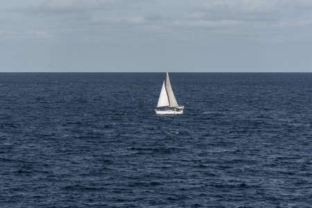 Formentera, Spain: 2021 august 2: Sailboat heading north on a sunny morning at Punta Prima on the...