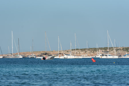 Es Pujols, Formentera, Spain: 2021 August 06: People enjoying the Es Pujols beach in Formentera, Spain in the summer of 2021.のeditorial素材