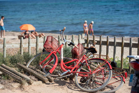 Formentera, Spain: 2021 August 17: Rental Bike on Mijorn beach in Formentera, Spain in summer.のeditorial素材