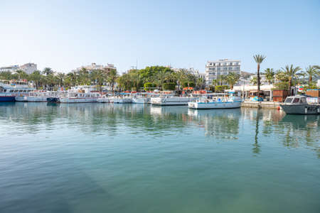 Sant Antoni de Portmany, Spain : 2022 April 18 : Boat in Panorama of the city of Sant Antoni de...
