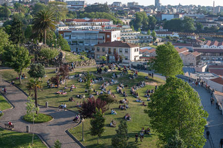Port, Portugal. 2022 05 May . People in the Jardim do Morro near the Bridge over the Douro Luis II River in Porto, Portugal in Summer 2022.のeditorial素材