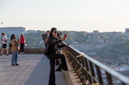 Port, Portugal. 2022 May 06 . Woman Taking a photo at Jardim do Morro in the summer of 2022.のeditorial素材