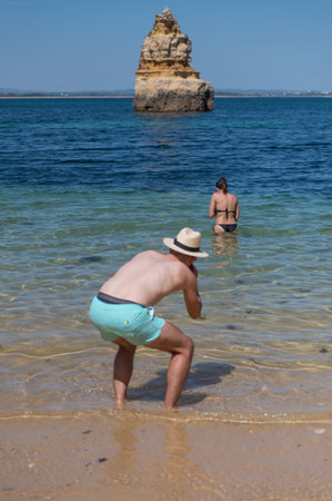 Lagos, Portugal. 2022 May 06 . Tourists taking photos in Praia do Camilo de Lagos in the Algarve, Portugal in the summer of 2022.のeditorial素材
