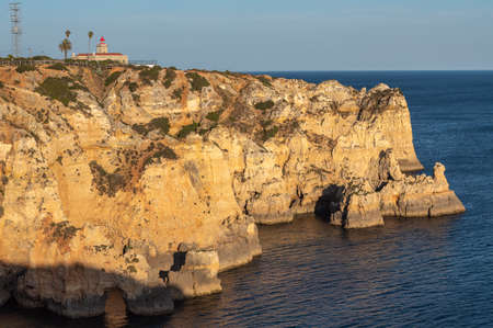 Ponta de Piedade lighthouse on the Algarve coast in Lagos, Portugal.の写真素材