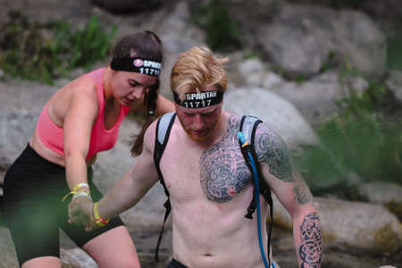 Encamp, Andorra : 2022 June 11 : Competitors participate in the 2020 Spartan Race obstacle racing...