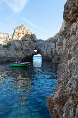 Lagos, Portugal. 2022 May 06 . Boat excursions to visit the caves to the cave of the tourist Praia do Camilo de Lagos in the Algarve, Portugal in the summer of 2022.のeditorial素材