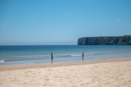 Sagres, Portugal. 2022 May 7. People in Praia da Mareta in the tourist city of Sagres in the Algarve, Portugal in the summer of 2022.のeditorial素材