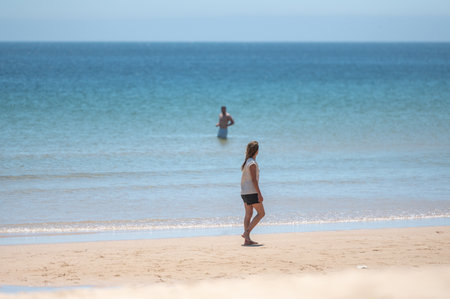 Sagres, Portugal. 2022 May 7. People in Praia da Mareta in the tourist city of Sagres in the Algarve, Portugal in the summer of 2022.のeditorial素材