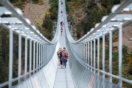 Canillo, Andorra. 2022 June 9. People walking on the longest Tibetan bridge in Europe, 600 meters long and 200 meters high in the Parish of Canillo in Andorra.のeditorial素材