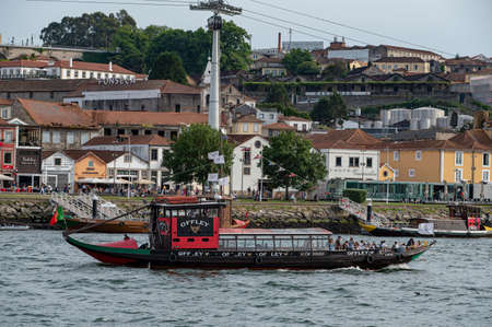 Port, Portugal. 2021 05 May . Tourist boat in Porto on the Douro river with the Luis II bridge in Porto, Portugal in the summer of 2022.のeditorial素材