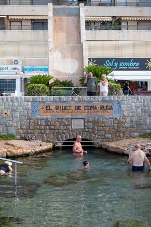 Coma Ruga, Spain. 2022 June 30 . People in the hot springs at the Riuet on the Comarruga beach in Tarragona, Spain.のeditorial素材