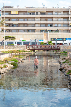Coma Ruga, Spain. 2022 June 30 . People in the hot springs at the Riuet on the Comarruga beach in Tarragona, Spain.のeditorial素材