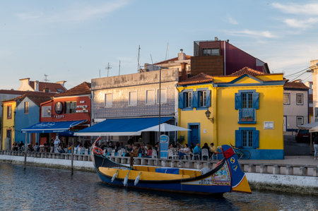 Aveiro, Portugal. 2022 May 12 . Traditional boats in the canal of Aveiro, Portugal. The colorful Moliceiro de Aveiro boat tours are popular with tourists to enjoy views of the charming canals. Aveiro, Portugal.のeditorial素材