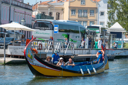 Aveiro, Portugal. 2022 May 12 . Traditional boats in the canal of Aveiro, Portugal. The colorful Moliceiro de Aveiro boat tours are popular with tourists to enjoy views of the charming canals. Aveiro, Portugal.のeditorial素材